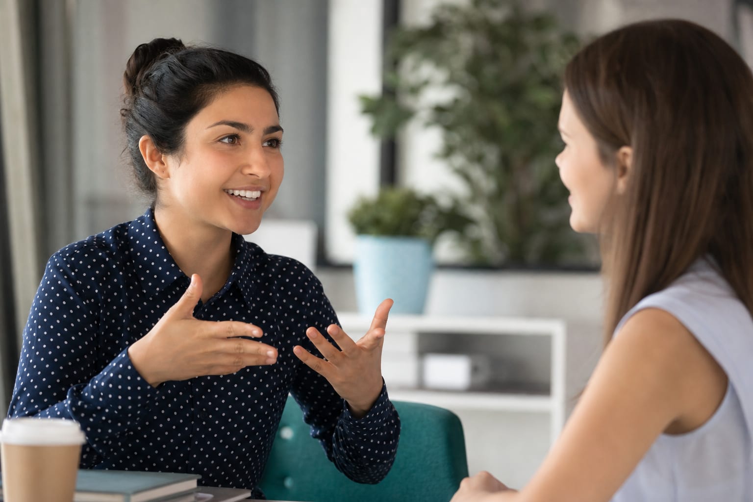 A person speaking confidently into a phone while soft speech bubbles float around them, grammar symbols fading into the background